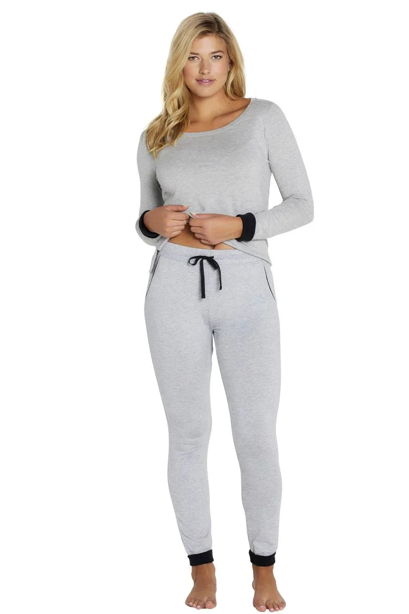 Woman wearing heather gray long sleeve loungewear set with black trim, relaxed pose