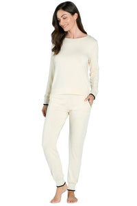 Woman wearing almond-colored long sleeve loungewear set with black trim, Pima cotton