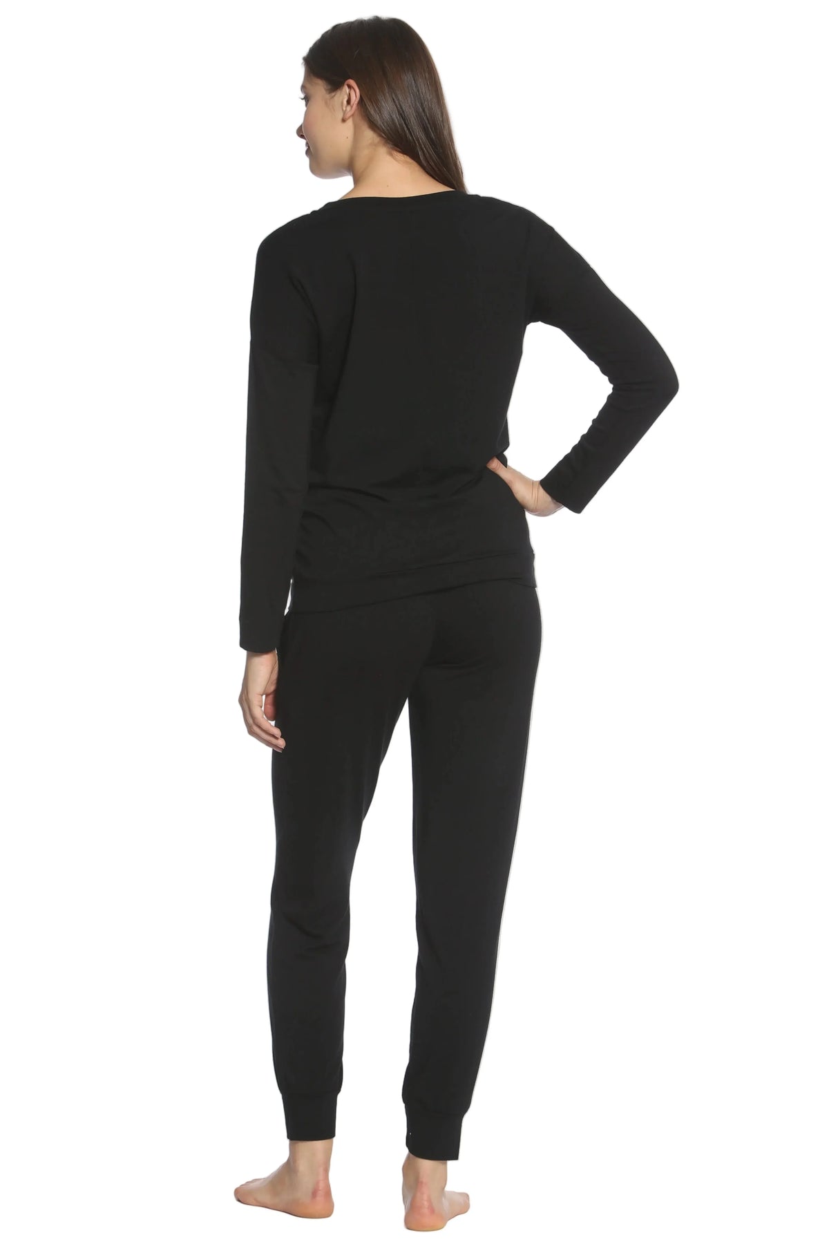 Woman wearing black long sleeve loungewear pajama set, back view, on white background