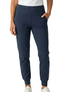 Woman wearing steel blue cotton jogger pants with pockets and white sneakers