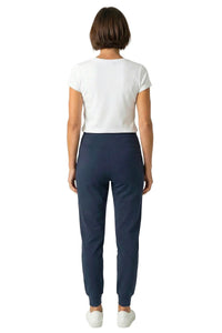 Woman in white short-sleeve tee and steel blue lounge joggers, back view, on white background