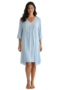 Woman wearing light blue lace-trimmed robe and nightgown loungewear set