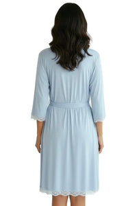 Woman wearing light blue knee-length robe with lace trim, soft loungewear sleepwear