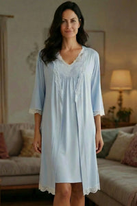 Woman wearing light blue lace-trimmed loungewear robe in cozy living room setting