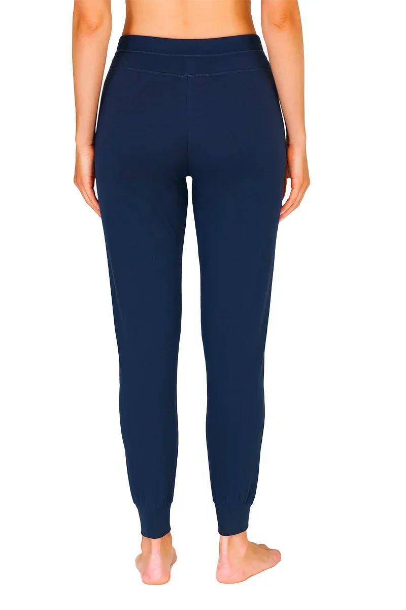 Back view of a woman wearing midnight blue Pima cotton loungewear jogger pants