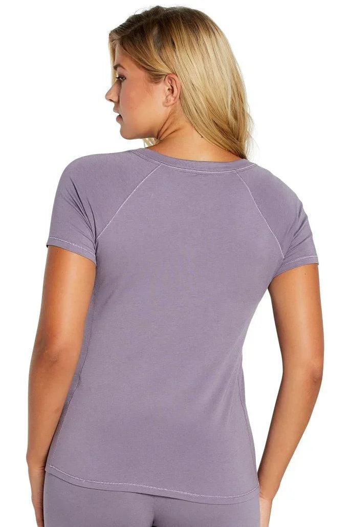 Back view of a woman wearing a Twelve Eighty Eight Olivia short sleeve Henley tee in purple.