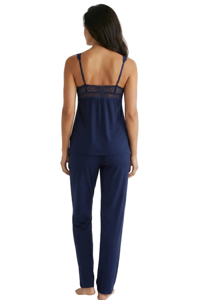 Woman wearing indigo blue Pima cotton loungewear set with lace detail, back view