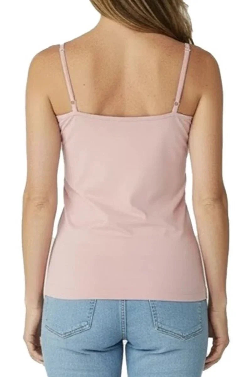 Back view of woman wearing shell pink camisole top and light blue jeans