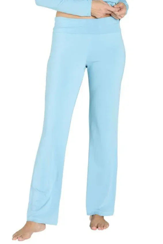 Light blue fold-down lounge pants worn by a barefoot model against white background