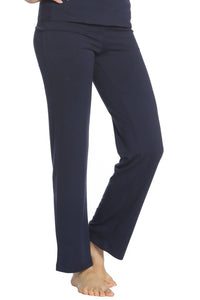 Woman wearing midnight blue yoga pants with a straight leg fit barefoot on white background