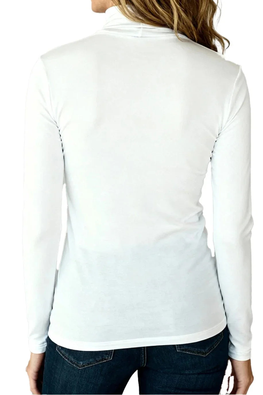 Back view of woman wearing white long-sleeve fitted turtleneck shirt and dark jeans
