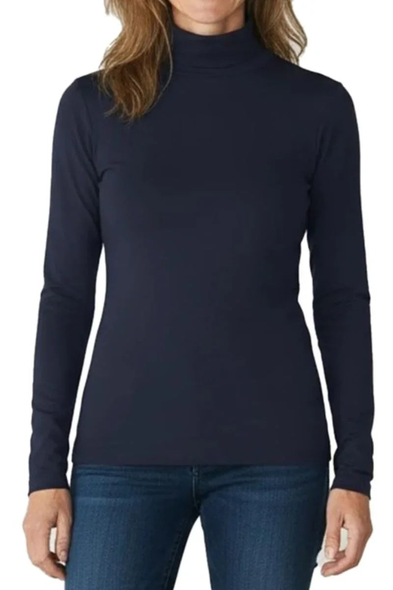 Woman wearing a midnight blue long-sleeve turtleneck top paired with blue jeans