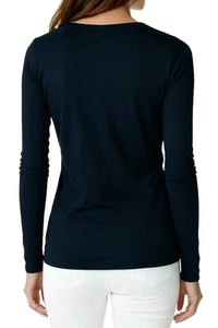 Back view of woman wearing black long-sleeve shirt and white pants on white background