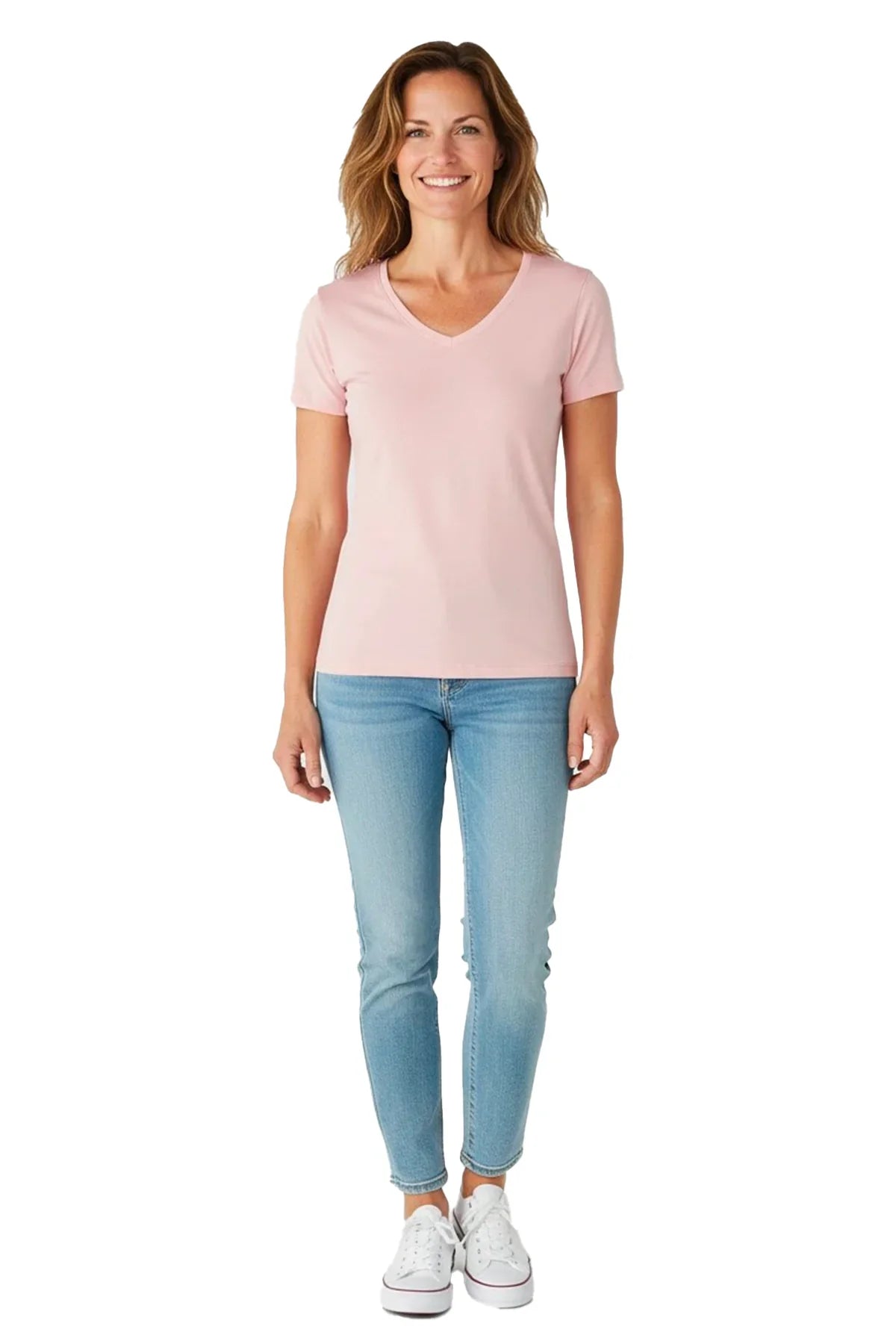 Smiling woman wearing a light pink V-neck T-shirt, light blue jeans, and white sneakers on white background