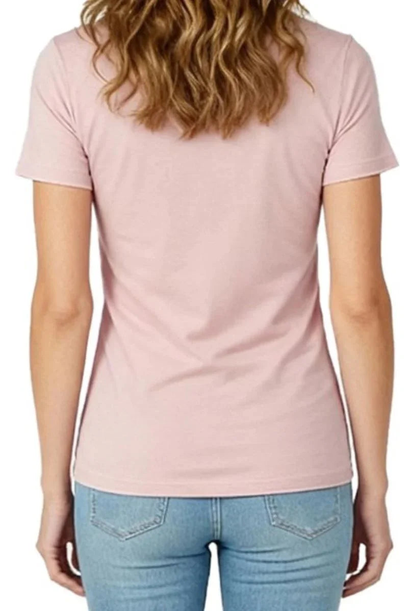 Back view of woman wearing shell pink fitted short sleeve t-shirt and light blue jeans