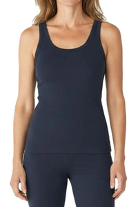 Woman wearing a steel blue sleeveless tank top and matching leggings against a white background