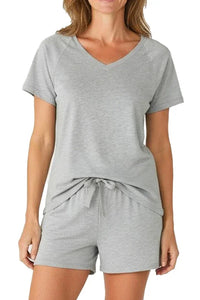 Woman wearing heather gray short sleeve V-neck top and matching drawstring shorts lounge set