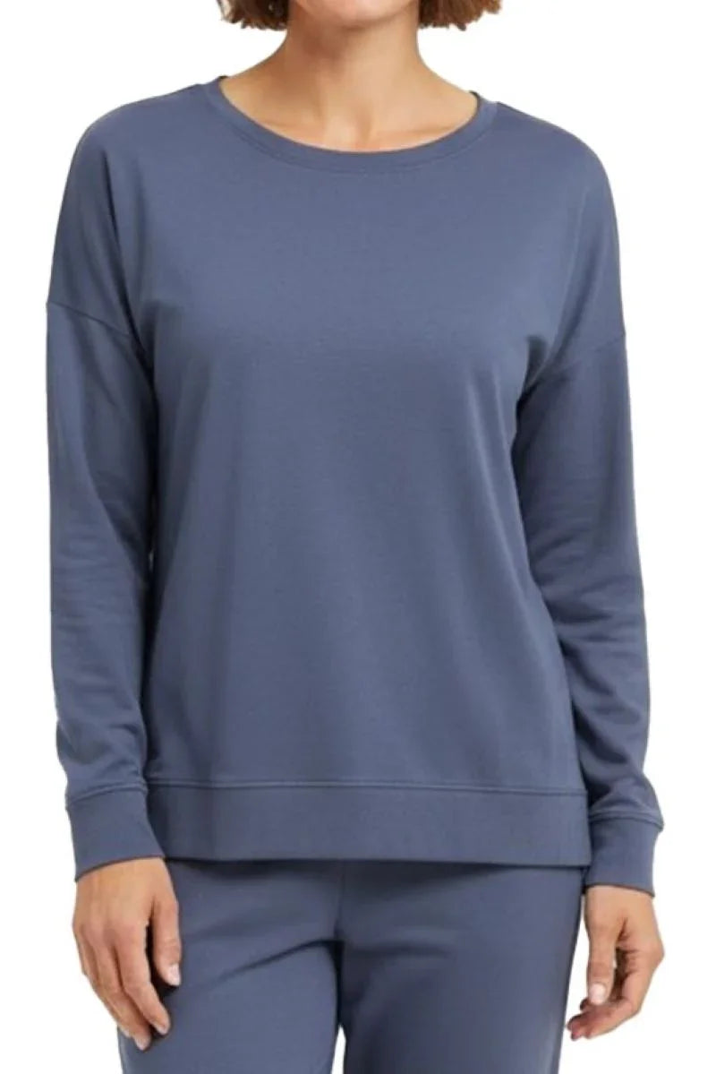Woman wearing steel blue long-sleeve crewneck sweatshirt and matching pants