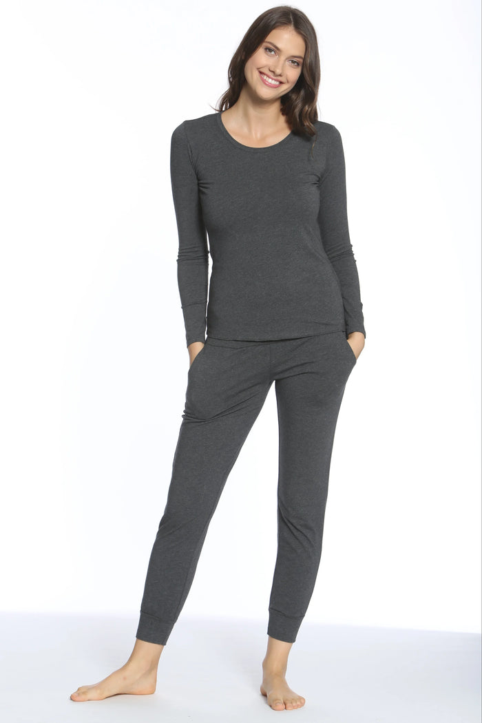 Smiling woman wearing dark charcoal long-sleeve top and matching jogger pants loungewear set