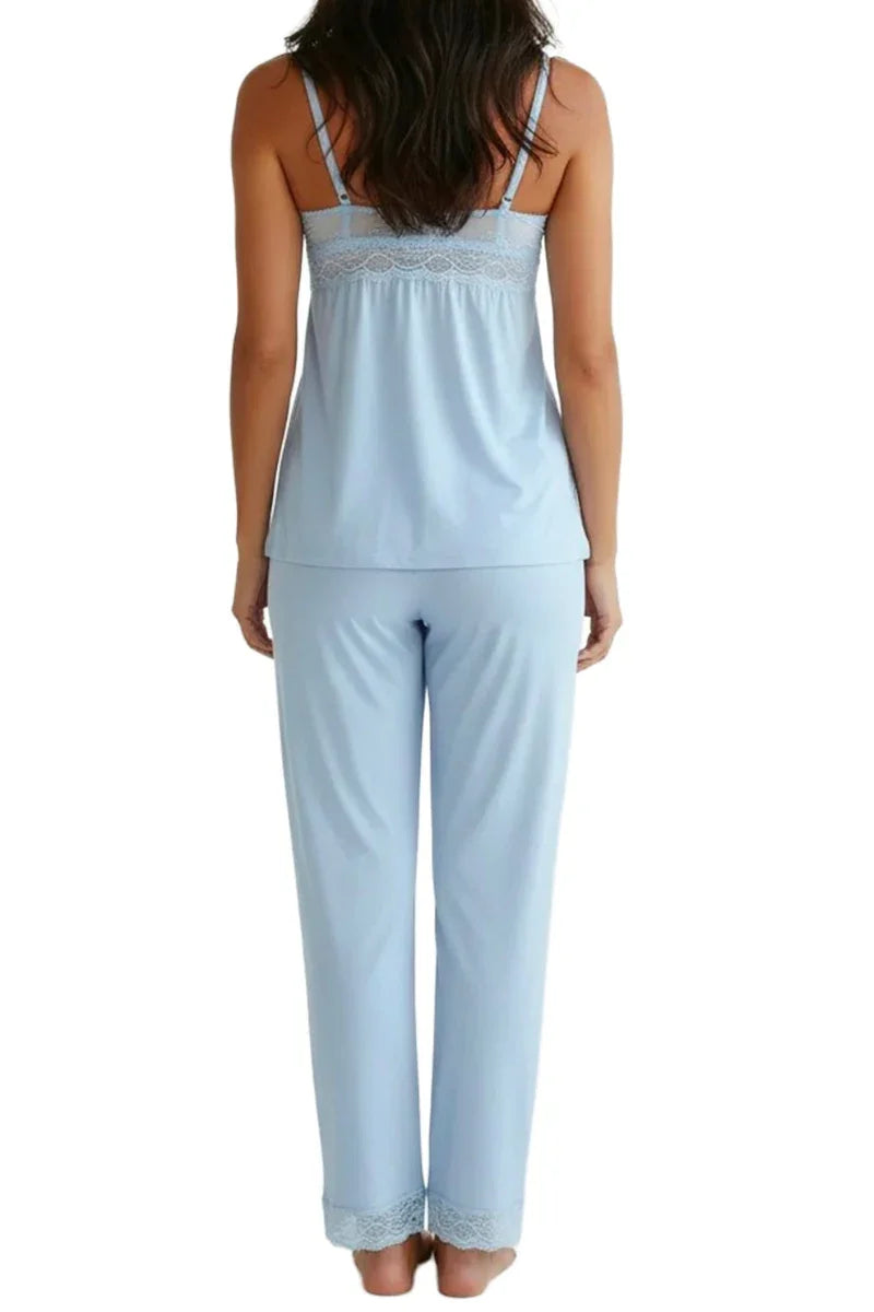 Back view of woman wearing light blue lace-trimmed camisole and pajama pants set