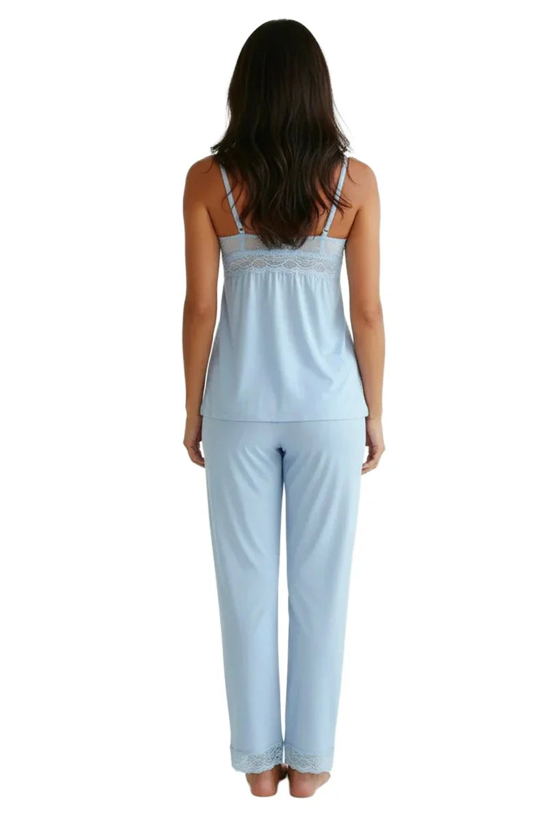 Woman wearing light blue chambray pajama set with lace trim, back view on white background