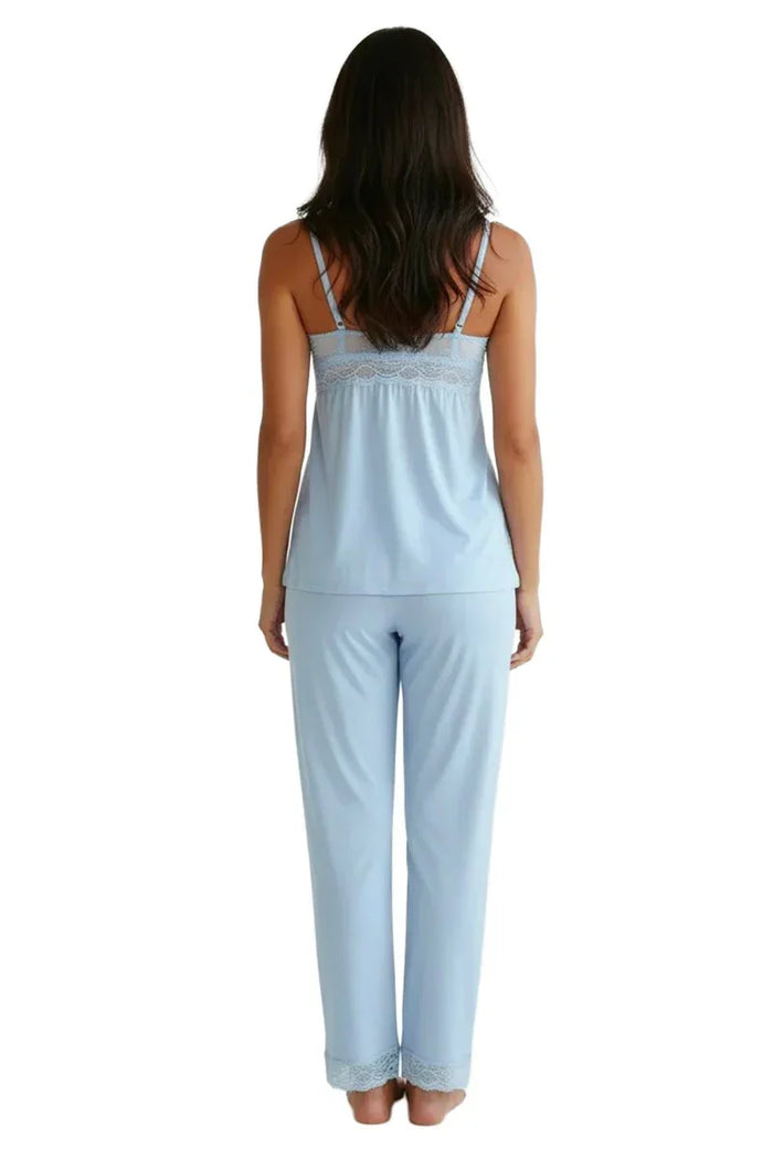 Woman wearing light blue spaghetti strap camisole pajama set with lace trim, back view
