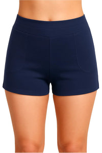 Close-up of woman wearing navy blue athletic shorts with front pockets on white background