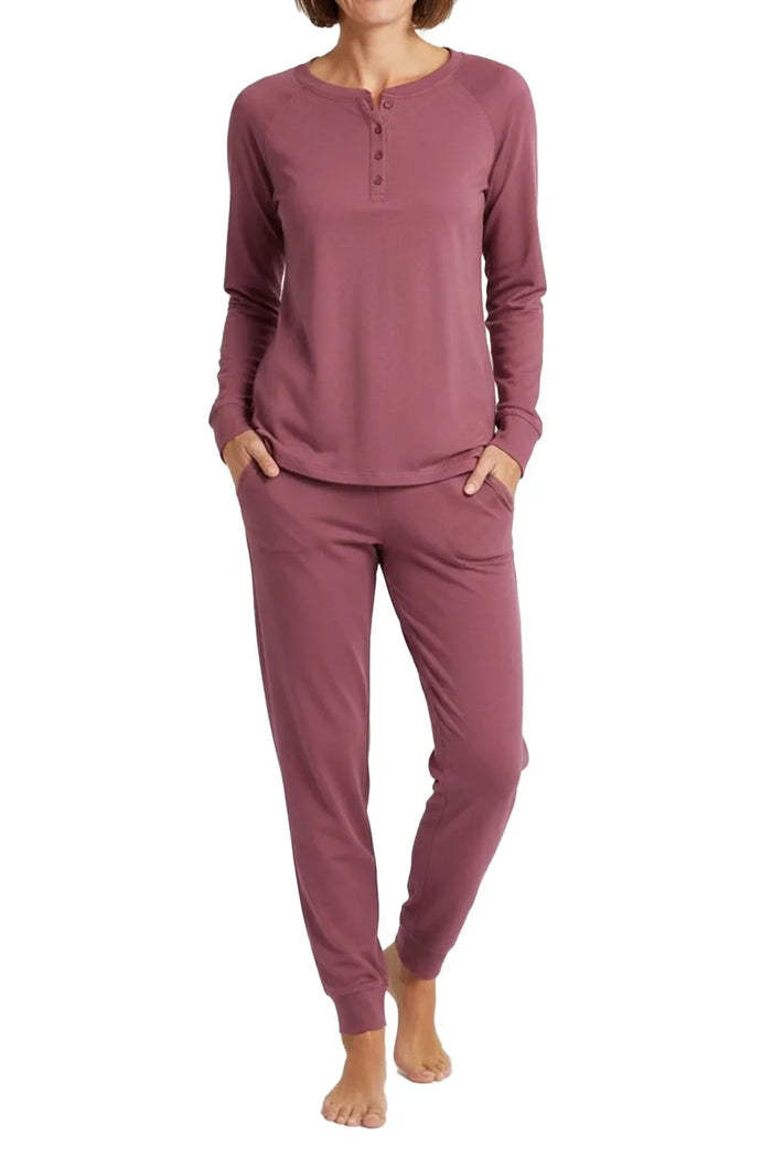 Woman wearing rosewood long sleeve henley top and matching jogger pants loungewear set