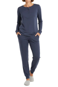 Woman wearing steel blue long-sleeve henley top and matching jogger pants with gray slippers