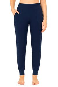 Front view of woman wearing midnight blue jogger pants with pockets and cuffed ankles