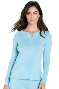 Woman wearing sky blue long-sleeve henley shirt with buttons and matching pants on white background